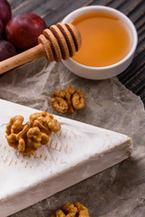 delicious creamy camembert cheese on a wooden rustic background