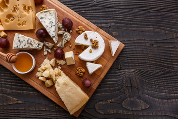 set of different cheeses on a wooden rustic background