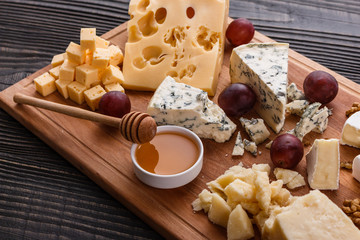 set of different cheeses on a wooden rustic background