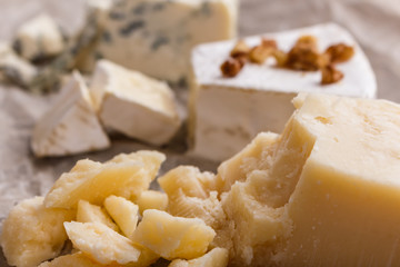 set of different cheeses on a wooden rustic background