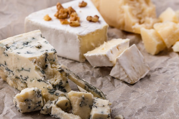 set of different cheeses on a wooden rustic background