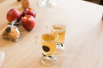 2 cups of tea on the table. red apple. hot tea