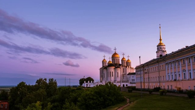 Vladimir, Russia. View of Cathedral of Assumption in Vladimir, Russia in the evening. Empty lawn in front of the landmark. Golden Ring tour in summer. Time-lapse at sunset, zoom in