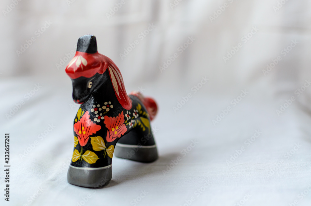 Wall mural Russian toy-horse on white background