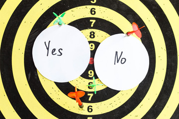 Target with darts in the center of which the inscription yes and no