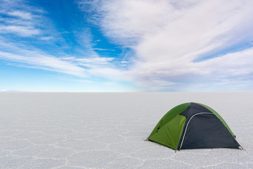 Lonely Tourist Tent in wide white Salt Desert Salar de Uyuni Bolivia