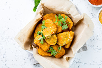 Healthy vegetarian nuggets with carrots, cauliflower and spinach. Vegetable nuggets. Vegan food. Top view, white background