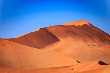 Naklejka na ściany i meble Dunes in Namib Naukluft Park Desert in Front of Blue Sky