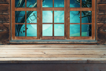 Empty wooden table over wooden window background.