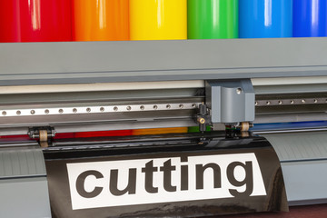 Cutting plotter close-up. The process of cutting a vinyl film. - obrazy, fototapety, plakaty