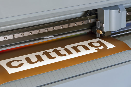 Cutting plotter close-up. The process of cutting a vinyl film.