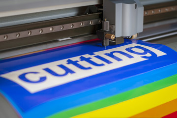 Cutting plotter close-up. The process of cutting a vinyl film.