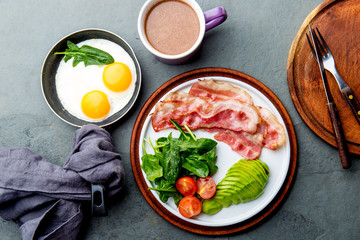 Ketogenic diet breakfast. fried egg, bacon and avocado, spinach and bulletproof coffee. Low carb high fat breakfast