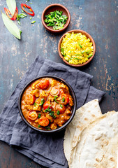 INDIAN FOOD. ROGAN JOSH curry sauce. Pork rogan josh with rice and naan bread