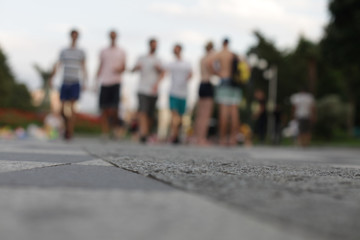 Abstract city light blur blinking background. Soft focus. Group of people view from below.