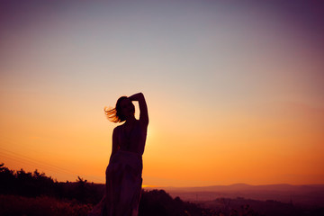 Silhouette of a girl at sunset