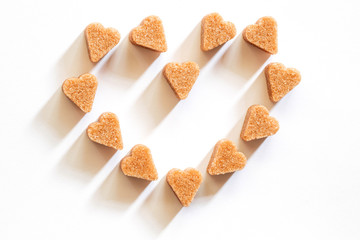 Heart shaped of brown sugar on white background