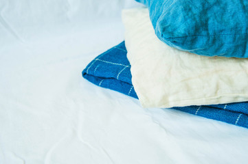 Soft, cozy blue blanket on white wooden background. Autumn comfort, space for text, top view flat...