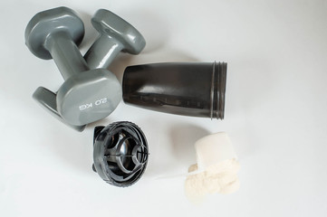 Bottle with protein shake and powder on white background. Sport, healthy lifestyle