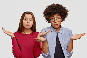 Clueless mixed race females with uncertain expressions, recieve question, cant answer it, stand...