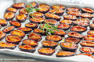 Spicy dried plums and a sprig of fresh rosemary.