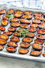 Parchment with dried plums and rosemary.