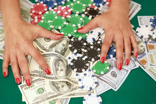 Woman gambling at casino with cash and chips 