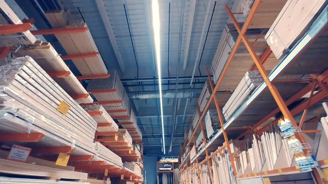Warehouse interior with wooden products on shelves. Dolly shot