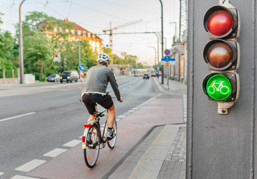 Fototapeta Traffic light with green bicycle sign, road safety and transportation in the city concept