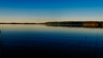 sunset at saimaa lake in finland
