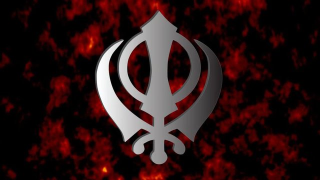 The main symbol of Sikhism – sign Khanda (silver)  on the background of fire, video 4K
