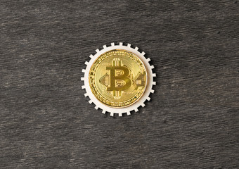 bitcoin, gear on a wooden background. virtual money. electronic business.