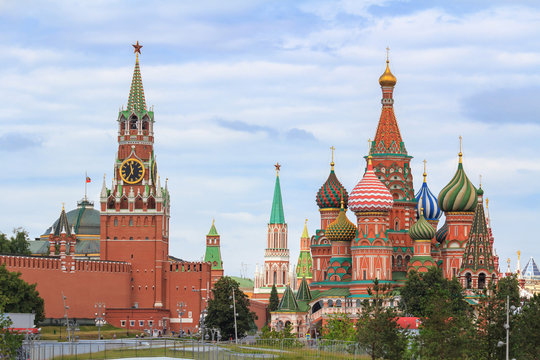 St. Basil's Cathedral on Red square and Moscow Kremlin with Spasskaya tower on a cloudy sky background in summer day