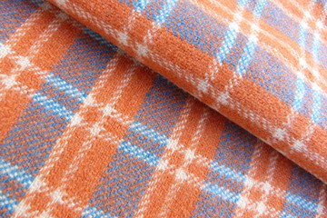 woolen checkered fabric close-up orange blue drape