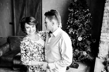 Beautiful parental couple in a New Year's interior