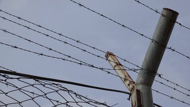 Barbed wire on a gloomy sky