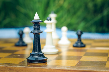 soft focus creative close foreshortening chess black and white figures on wooden classic yellow...