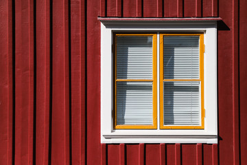 Window with blinds on red house