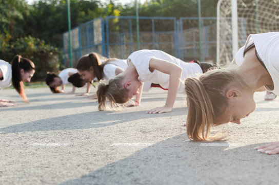 Group of young woman doing push-ups