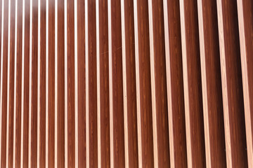 Wooden vertical slats on a wall background. Interior detail, texture, background. The concept of...