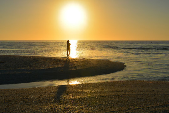 sunset on the beach - female silhouette - wellness 