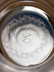 Nucleation marks engraved with a laser on the bottom of a glass to increase carbonation of beer.