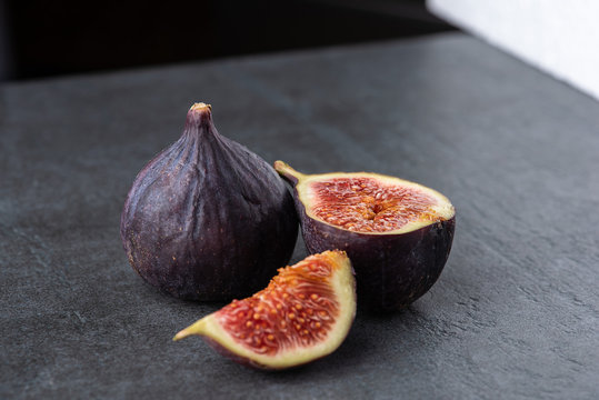 Fresh fruit isolated figs on the grey dark background