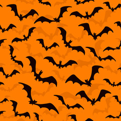 Seamless wallpaper with bats for Halloween on orange background