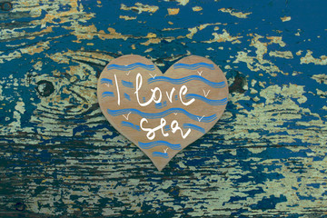loving sea card / a wooden heart   on the old  blue wooden background 