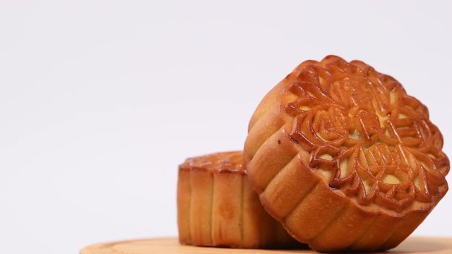Moon cakes rotating on white background,The Chinese character on the mooncake represent "Double white" in English