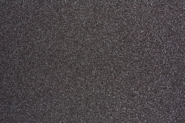 Сlose up of black sandpaper sheet texture, background or backdrop