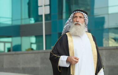 Senior Arabic man in traditional clothes outdoor portrait