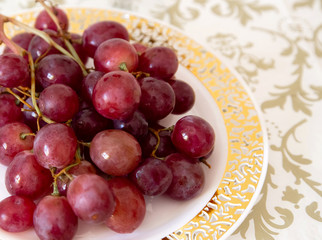 bunch of red grapes on a golden plate detail