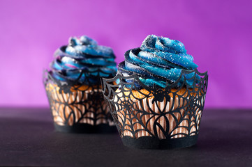 Cupcakes with galaxy whipped cream on violet background